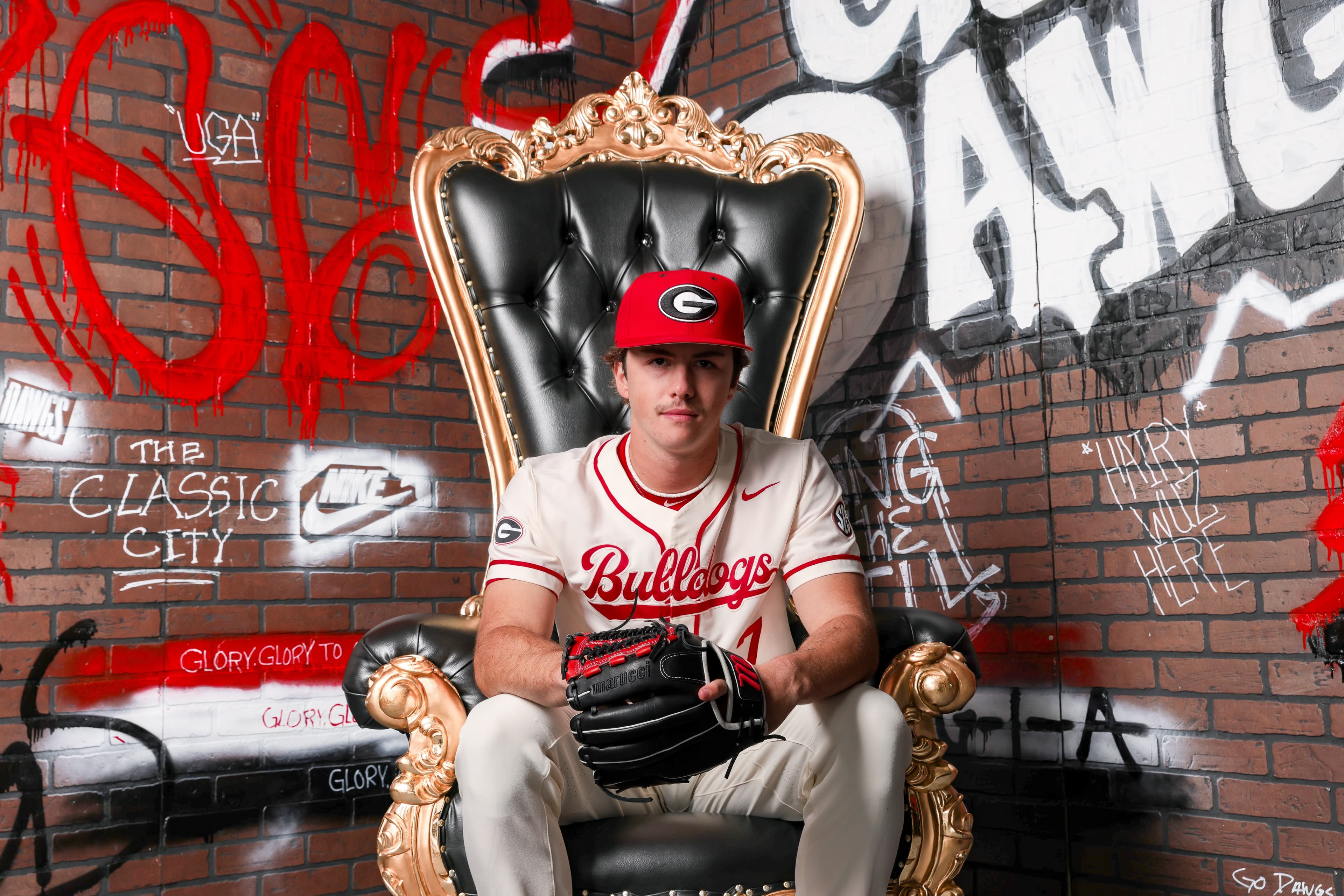 Dylan Alonso in Georgia Bulldogs jersey seated on throne chair during official visit